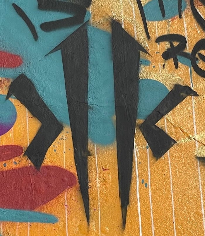 Detailed view of Kyrie Irving's ANTA logo on a mural in China.